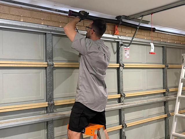 SnapDoor technician adjusting a sectional garage door